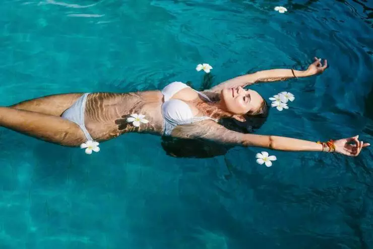 Beautiful women relaxing at the luxury poolside.